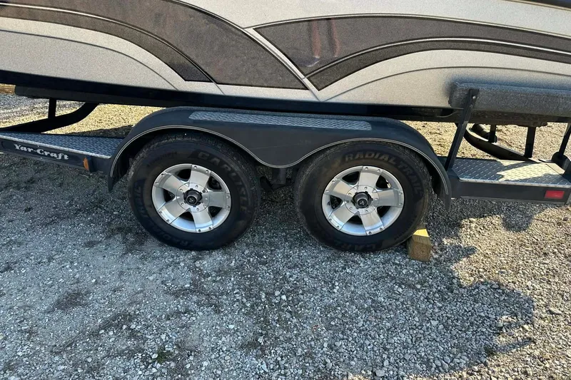 Slide: The Image of 2018 Yar-Craft 219TFX boat trailer with dual wheels on gravel surface. - 46