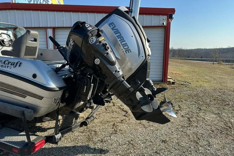Slide: The Image of 2018 Yar-Craft 219TFX boat with Evinrude outboard motor, parked outdoors. - 54