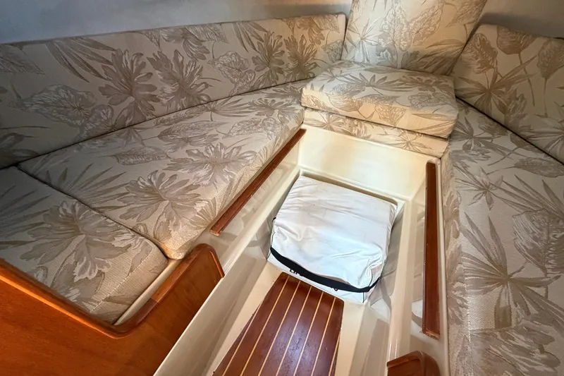 Slide: The Image of Interior of 2008 Ranger Tugs R-25 with floral upholstery and storage compartment. - 11