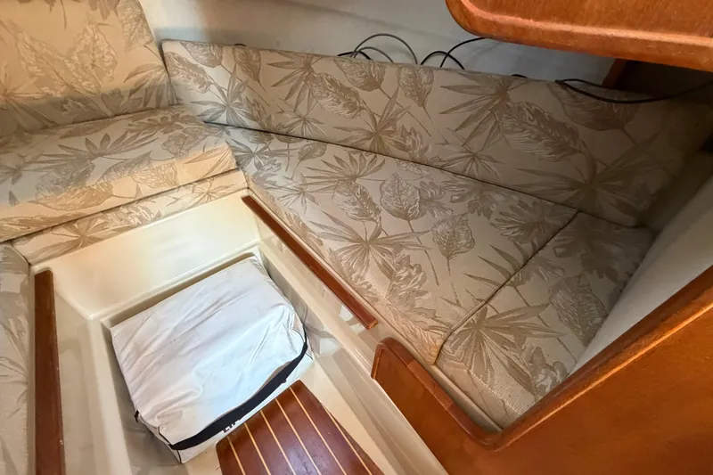 Slide: The Image of Interior cabin of 2008 Ranger Tugs R-25 with floral-patterned cushions and wooden accents. - 12