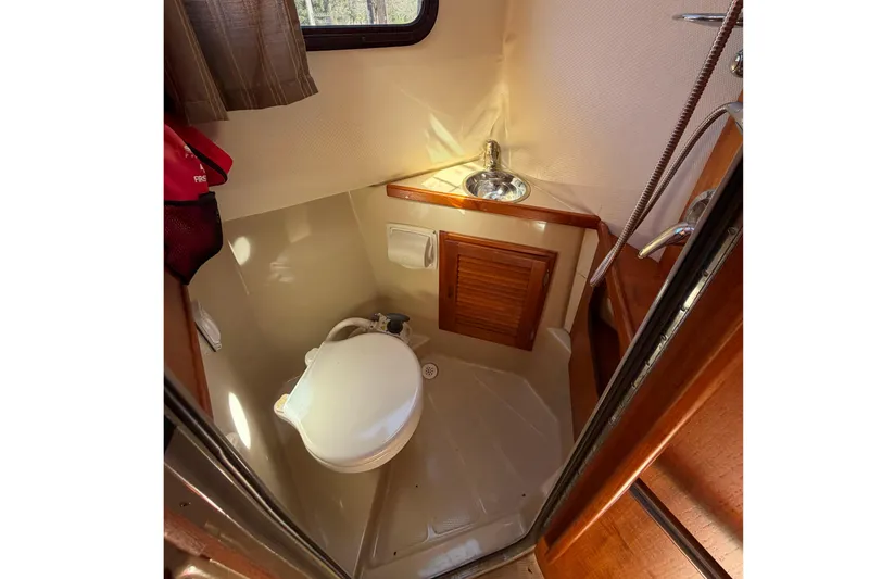 Slide: The Image of Compact bathroom in 2008 Ranger Tugs R-25 boat with toilet and sink. - 15