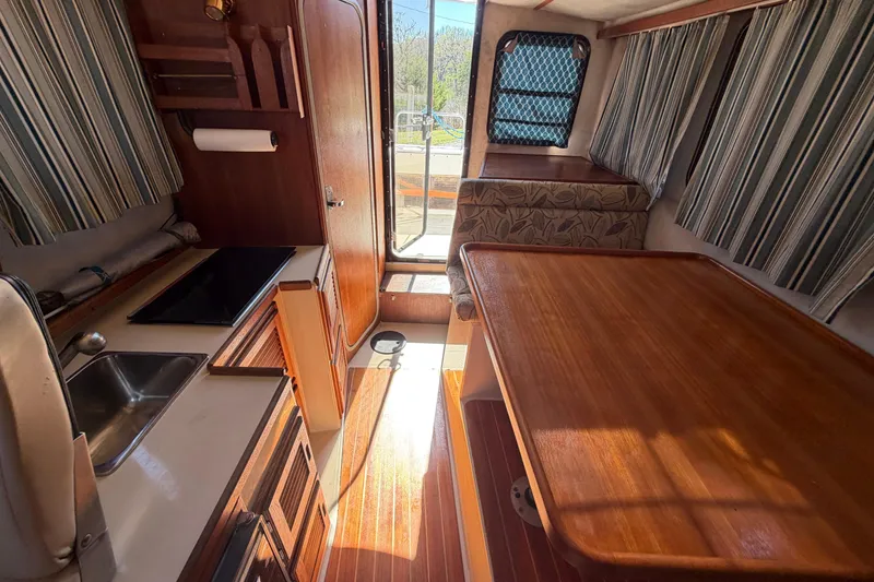 Slide: The Image of Interior of 2008 Ranger Tugs R-25 boat with kitchenette and dining area. - 8