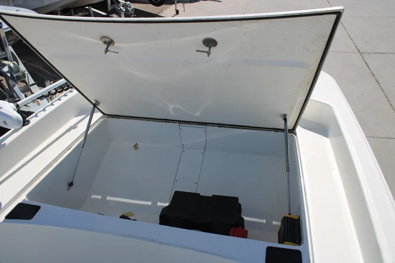 Slide: The Image of Open storage compartment on 2025 Mako Pro Skiff 17 CC boat. - 11