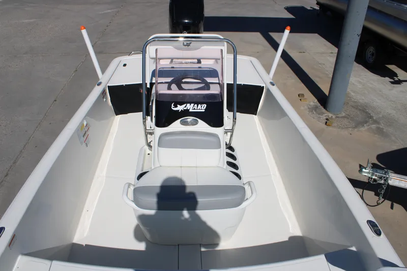 Slide: The Image of 2025 Mako Pro Skiff 17 CC boat interior with steering console and seating. - 12