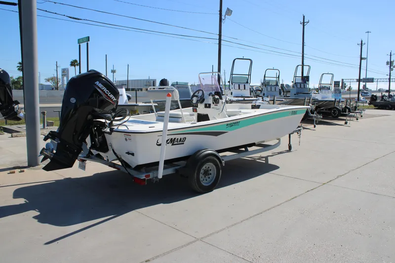 Slide: The Image of 2025 Mako Pro Skiff 17 CC boat on trailer in outdoor dealership lot. - 14
