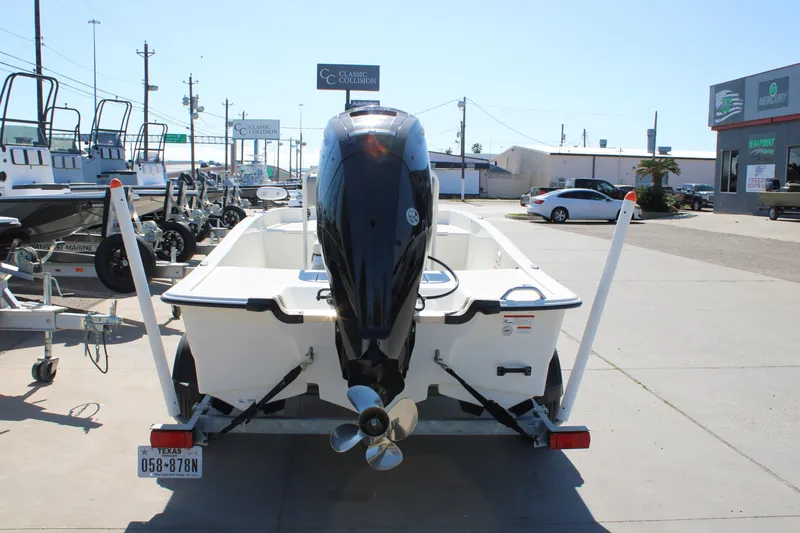 Slide: The Image of 2025 Mako Pro Skiff 17 CC boat on trailer, rear view in dealership lot. - 15