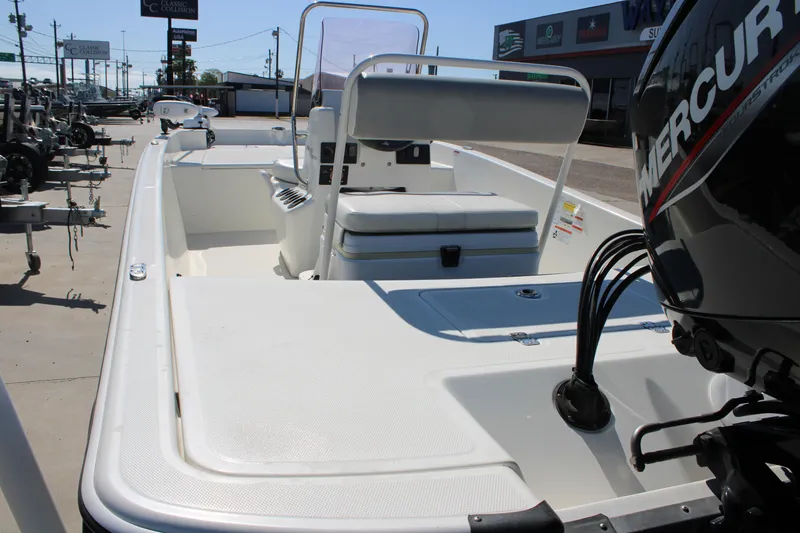 Slide: The Image of 2025 Mako Pro Skiff 17 CC boat with Mercury engine, displayed outdoors. - 17