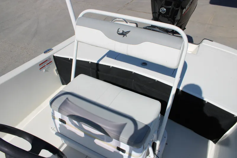 Slide: The Image of 2025 Mako Pro Skiff 17 CC boat interior with seating and steering wheel. - 8