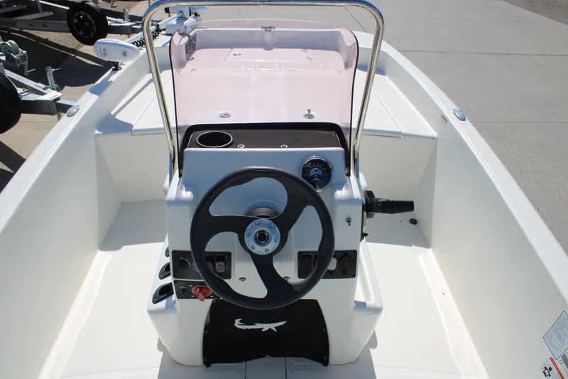 Slide: The Image of 2025 Mako Pro Skiff 17 CC boat console with steering wheel and controls. - 9