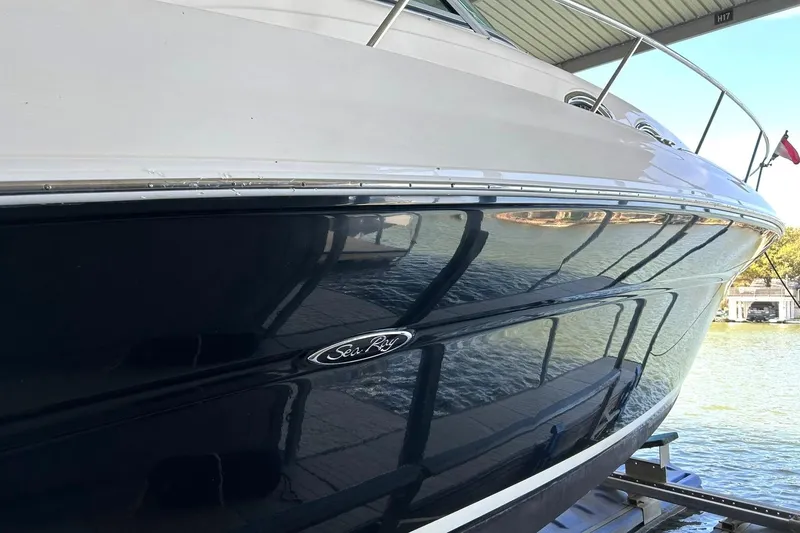 Slide: The Image of 2006 Sea Ray Sundancer 320 boat docked, reflecting water and surroundings. - 10