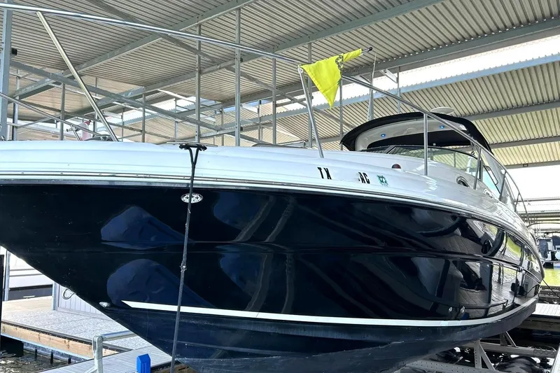 Slide: The Image of 2006 Sea Ray Sundancer 320 yacht docked under a metal canopy. - 15