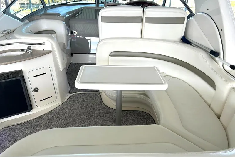 Slide: The Image of Interior of 2006 Sea Ray Sundancer 320 yacht with white seating and table. - 18