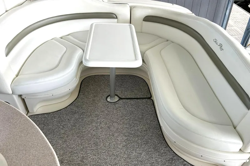 Slide: The Image of Interior seating area of a 2006 Sea Ray Sundancer 320 boat with a table. - 19