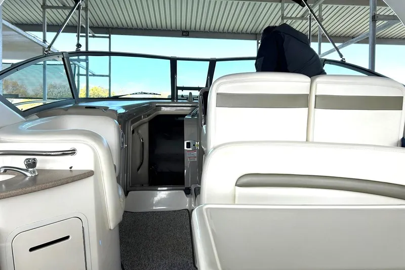 Slide: The Image of Interior view of a 2006 Sea Ray Sundancer 320 boat with white seating and helm. - 21