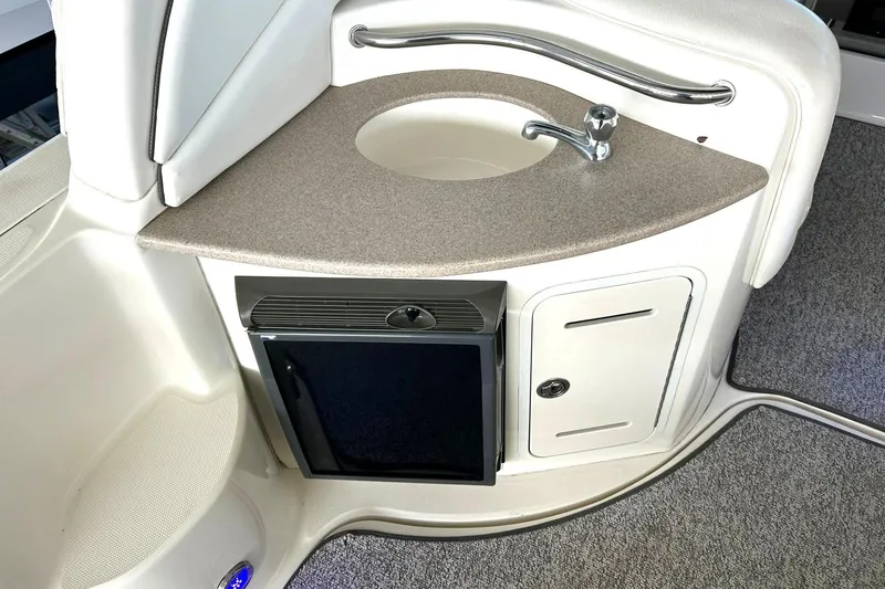 Slide: The Image of 2006 Sea Ray Sundancer 320 interior with sink, countertop, and mini fridge. - 22
