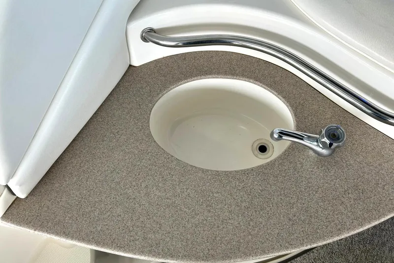 Slide: The Image of Sink area on a 2006 Sea Ray Sundancer 320 boat with chrome faucet. - 23