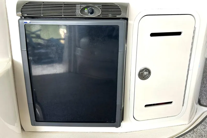 Slide: The Image of 2006 Sea Ray Sundancer 320 boat refrigerator and storage compartment. - 24