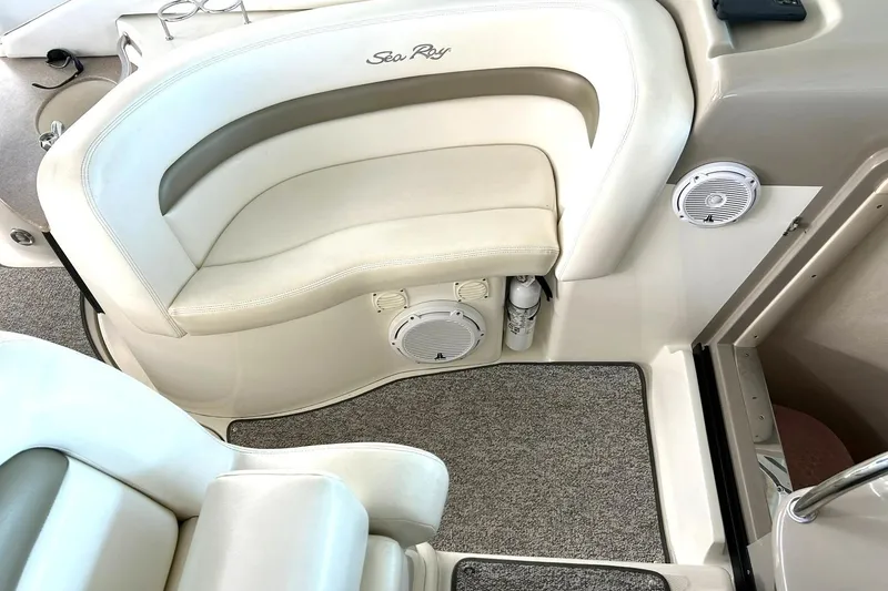 Slide: The Image of Interior seating of a 2006 Sea Ray Sundancer 320 boat with beige upholstery and speakers. - 27