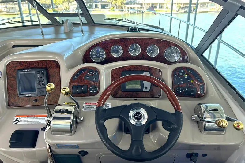 Slide: The Image of Helm of 2006 Sea Ray Sundancer 320 with steering wheel and control panel. - 31