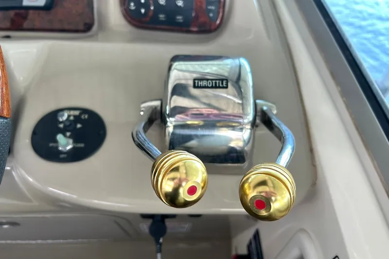 Slide: The Image of Throttle controls on a 2006 Sea Ray Sundancer 320 boat dashboard. - 33