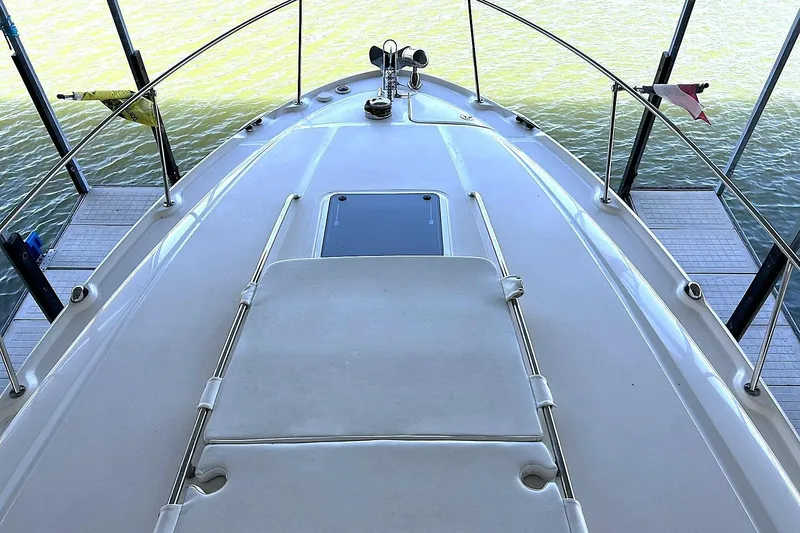 Slide: The Image of Bow view of 2006 Sea Ray Sundancer 320 yacht docked on calm water. - 37
