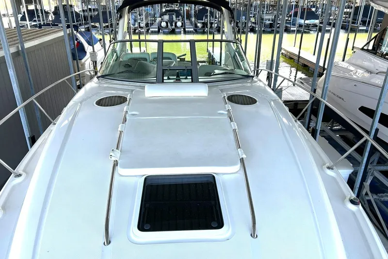 Slide: The Image of 2006 Sea Ray Sundancer 320 yacht docked in a marina, showcasing sleek design. - 39