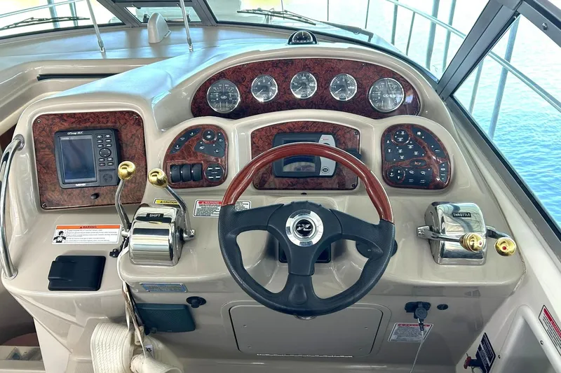 Slide: The Image of Cockpit of 2006 Sea Ray Sundancer 320 with steering wheel and control panel. - 4