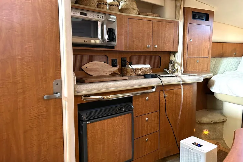 Slide: The Image of Interior of 2006 Sea Ray Sundancer 320 yacht with kitchenette and wooden cabinetry. - 44