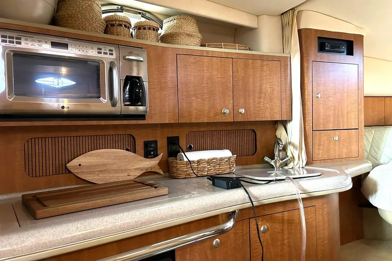 Slide: The Image of Interior of 2006 Sea Ray Sundancer 320 yacht kitchen with wooden cabinets and appliances. - 45