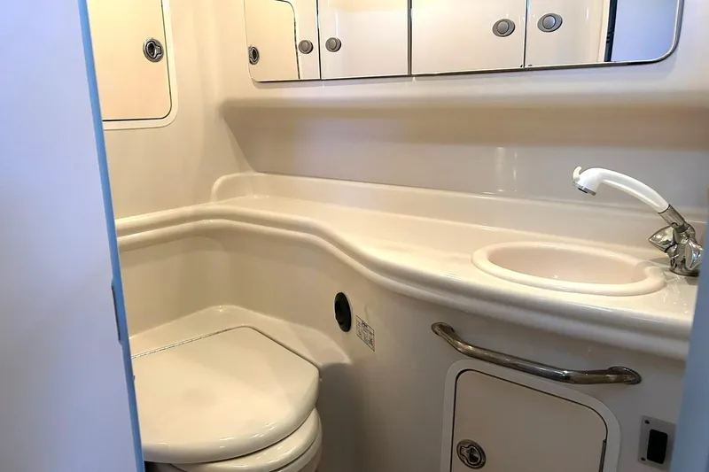 Slide: The Image of 2006 Sea Ray Sundancer 320 bathroom with sink, toilet, and storage cabinets. - 52
