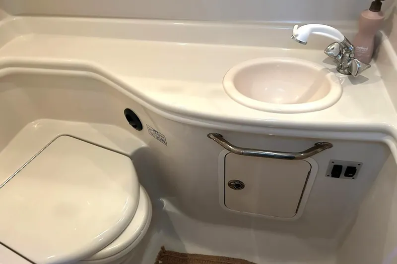 Slide: The Image of Bathroom interior of 2006 Sea Ray Sundancer 320 yacht, featuring sink and toilet. - 53
