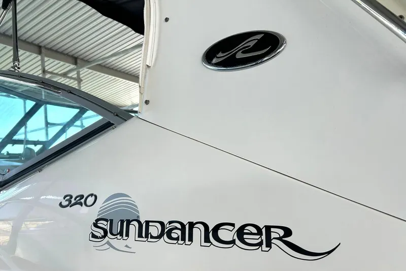 Slide: The Image of 2006 Sea Ray Sundancer 320 boat with logo and model name visible. - 59