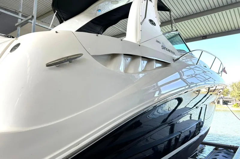 Slide: The Image of 2006 Sea Ray Sundancer 320 yacht docked under a covered marina. - 8