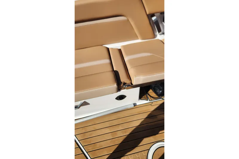 Slide: The Image of 2024 MasterCraft X24 boat interior with tan leather seating and teak flooring. - 10