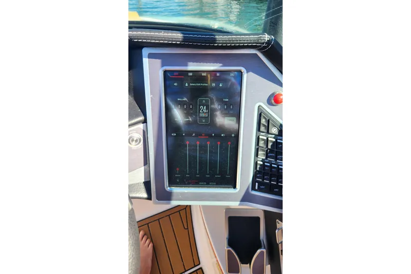 Slide: The Image of 2024 MasterCraft X24 boat dashboard with touchscreen controls and navigation system. - 18