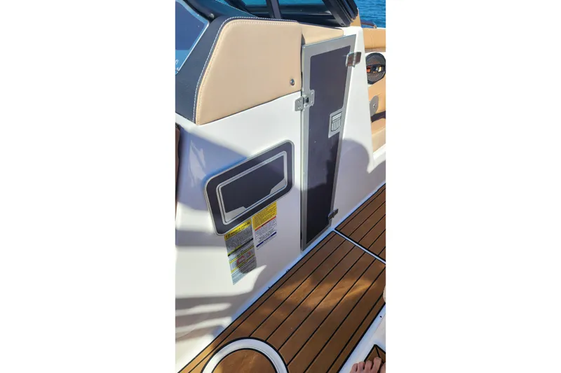 Slide: The Image of Interior view of 2024 MasterCraft X24 boat, featuring sleek design and wood flooring. - 19