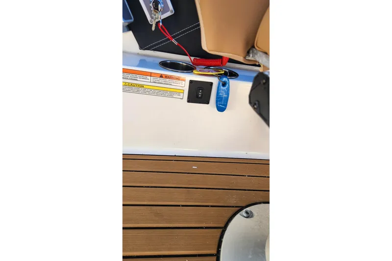 Slide: The Image of 2024 MasterCraft X24 boat interior with safety warnings and teak flooring. - 20