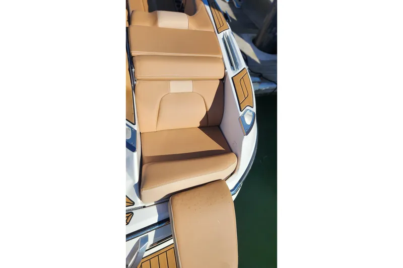 Slide: The Image of 2024 MasterCraft X24 boat with tan leather seating and sleek design. - 31