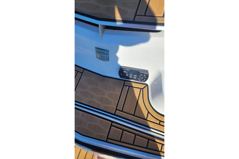 Slide: The Image of 2024 MasterCraft X24 boat deck with wood finish and control panel. - 33