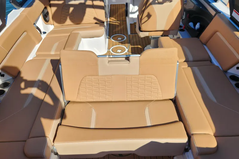 Slide: The Image of 2024 MasterCraft X24 boat interior with tan leather seating and wood accents. - 5