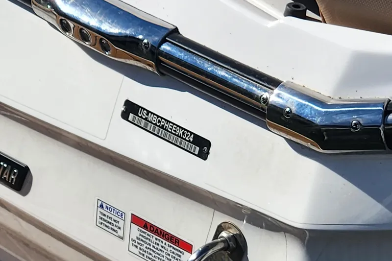 Slide: The Image of 2024 MasterCraft X24 boat with identification plate and safety warnings. - 9