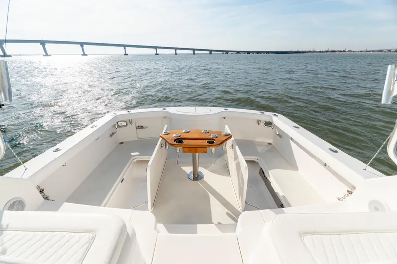 Slide: The Image of 2015 Ocean Yachts 37 Express boat deck with scenic ocean view and distant bridge. - 11
