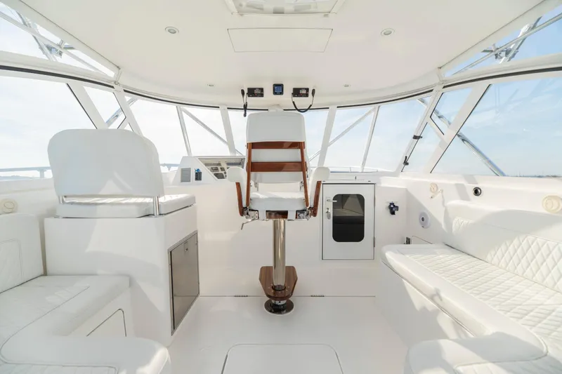 Slide: The Image of Luxurious interior of 2015 Ocean Yachts 37 Express, featuring white seating and helm. - 12