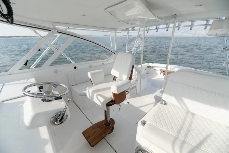 Slide: The Image of Luxurious 2015 Ocean Yachts 37 Express interior with white seating and ocean view. - 13