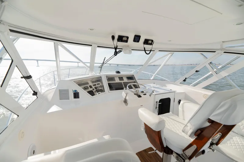 Slide: The Image of Interior view of 2015 Ocean Yachts 37 Express, featuring helm station and panoramic windows. - 15