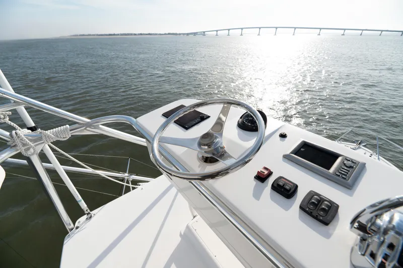 Slide: The Image of Helm of 2015 Ocean Yachts 37 Express with ocean view and distant bridge. - 7