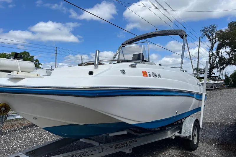 The Image of 2020 Hurricane Center Console 19 OB boat on trailer under blue sky. - 0