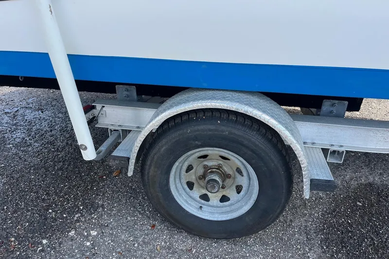 Slide: The Image of Trailer wheel of a 2020 Hurricane Center Console 19 OB boat on asphalt. - 13