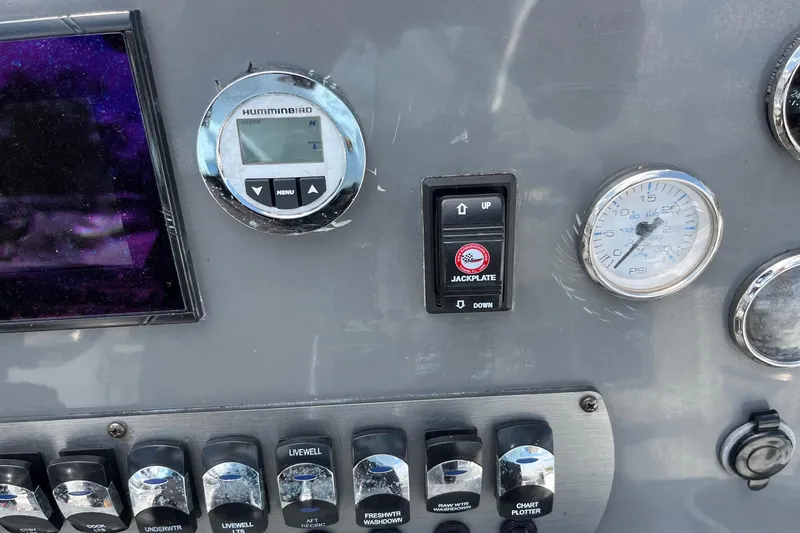 Slide: The Image of Control panel of 2020 Hurricane Center Console 19 OB boat with gauges and switches. - 2