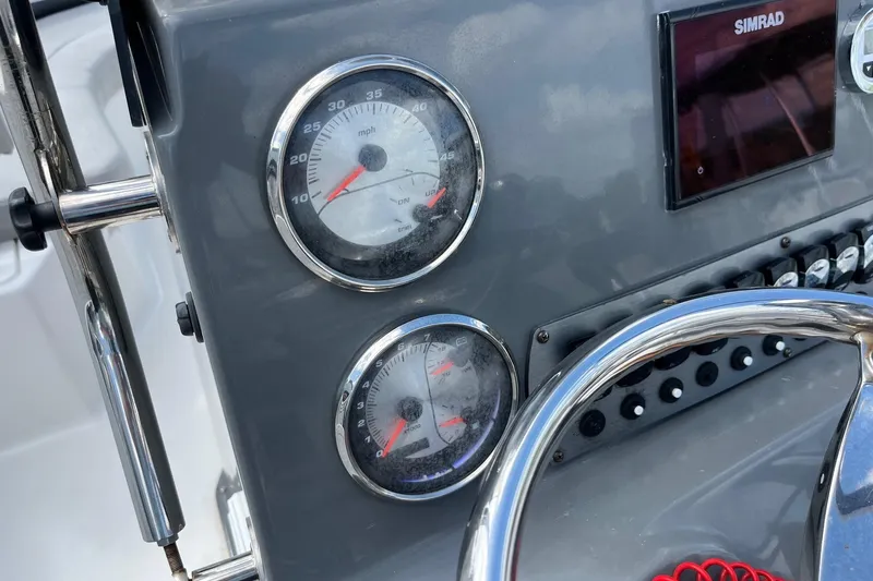 Slide: The Image of Dashboard of a 2020 Hurricane Center Console 19 OB boat with gauges and controls. - 4